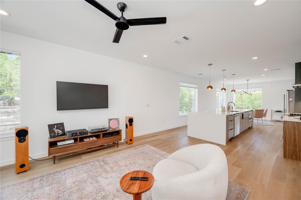 1208 Luna Street, Unit 1 Austin, TX 78721 - Photo 12 of 39 a living room with furniture and a flat screen tv