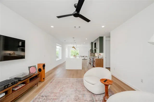 a living room with furniture a rug and white walls