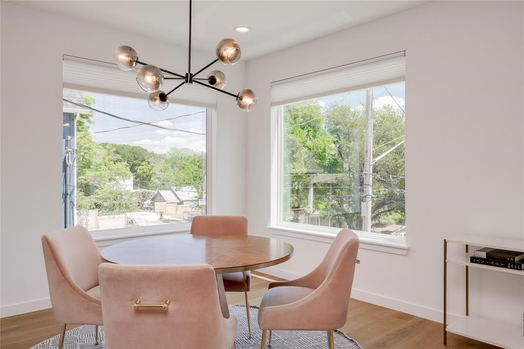 1208 Luna Street, Unit 1 Austin, TX 78721 - Photo 17 of 39 a dining room with furniture a chandelier and wooden floor