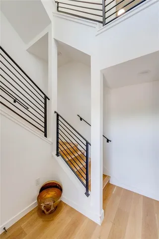 a view of a hallway with stairs and a window