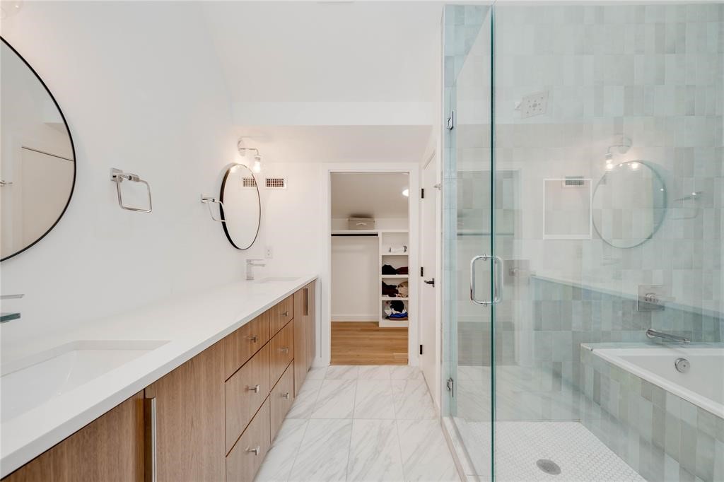 1208 Luna Street, Unit 1 Austin, TX 78721 - Photo 33 of 39 a bathroom with a granite countertop sink a mirror and a shower