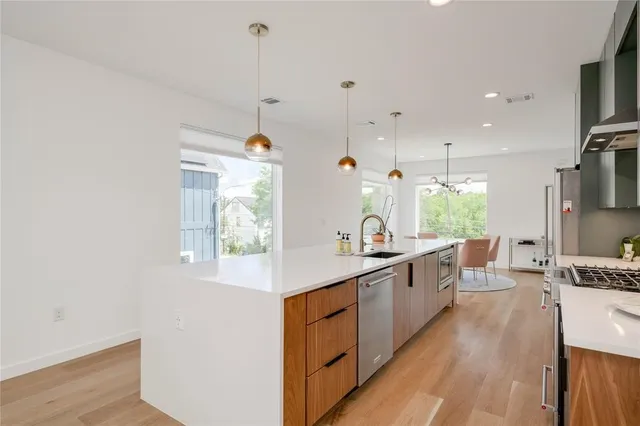 a kitchen with sink a stove and cabinets