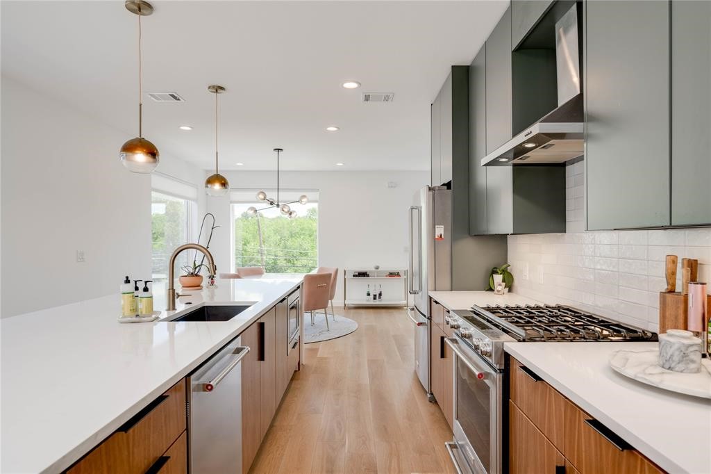 1208 Luna Street, Unit 1 Austin, TX 78721 - Photo 8 of 39 a kitchen with sink a stove and cabinets