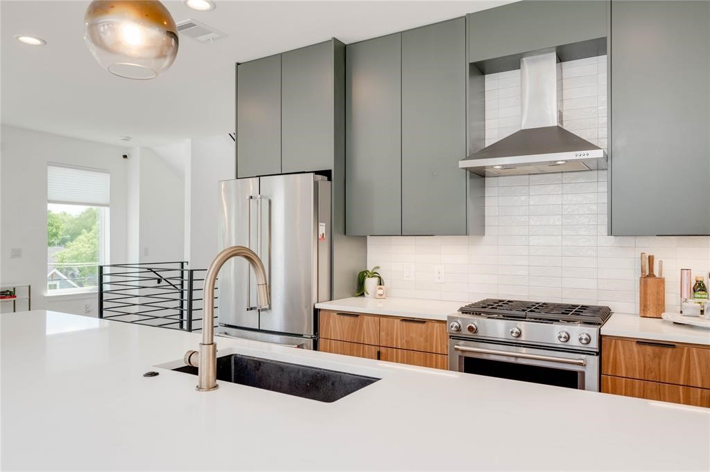 1208 Luna Street, Unit 1 Austin, TX 78721 - Photo 9 of 39 a kitchen with granite countertop a stove a sink and a refrigerator