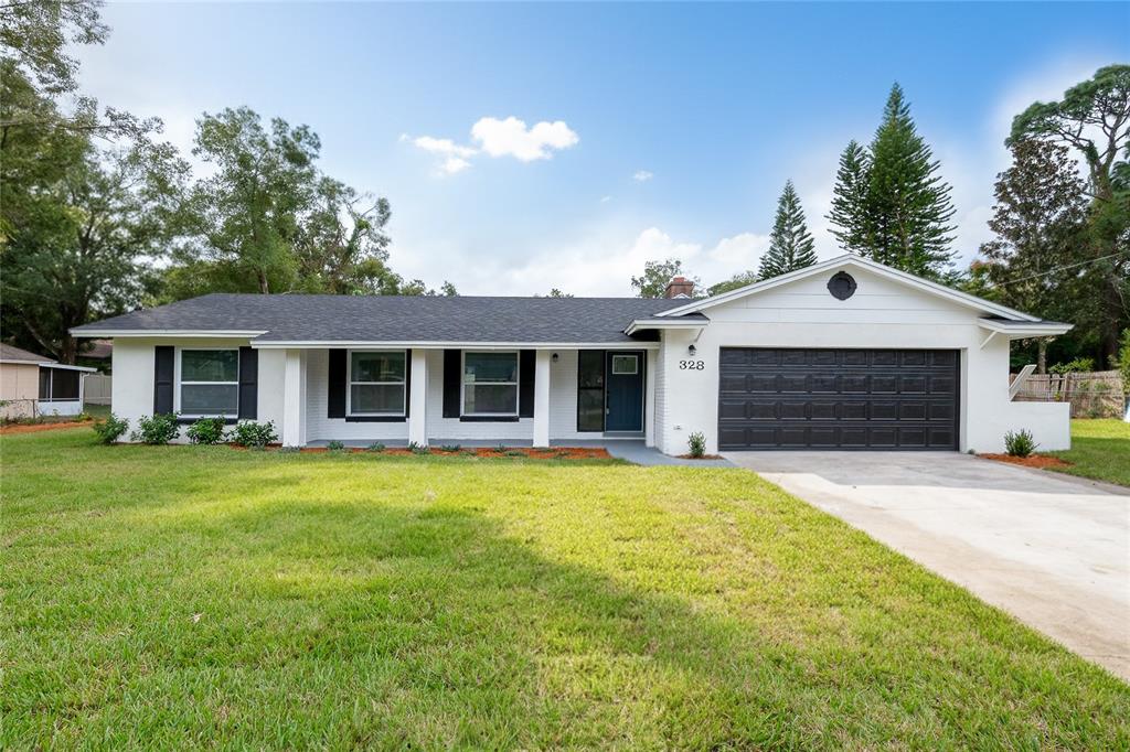 328 Alpine Street Altamonte Springs, FL 32701 - Photo 1 of 1 a front view of a house with a garden and yard