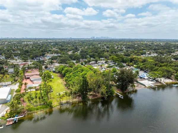 an aerial view of residential houses with lake view and boat