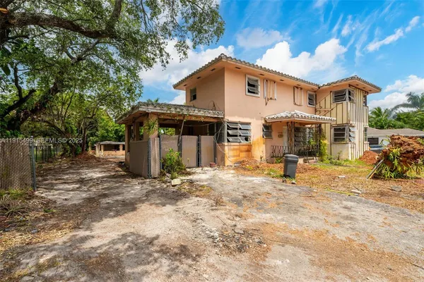 a view of a house with a patio and a yard