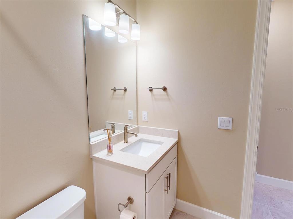 1352 Raspberry Dr Port North Port, FL 34289 - Photo 50 of 88 a bathroom with a sink a toilet and mirror