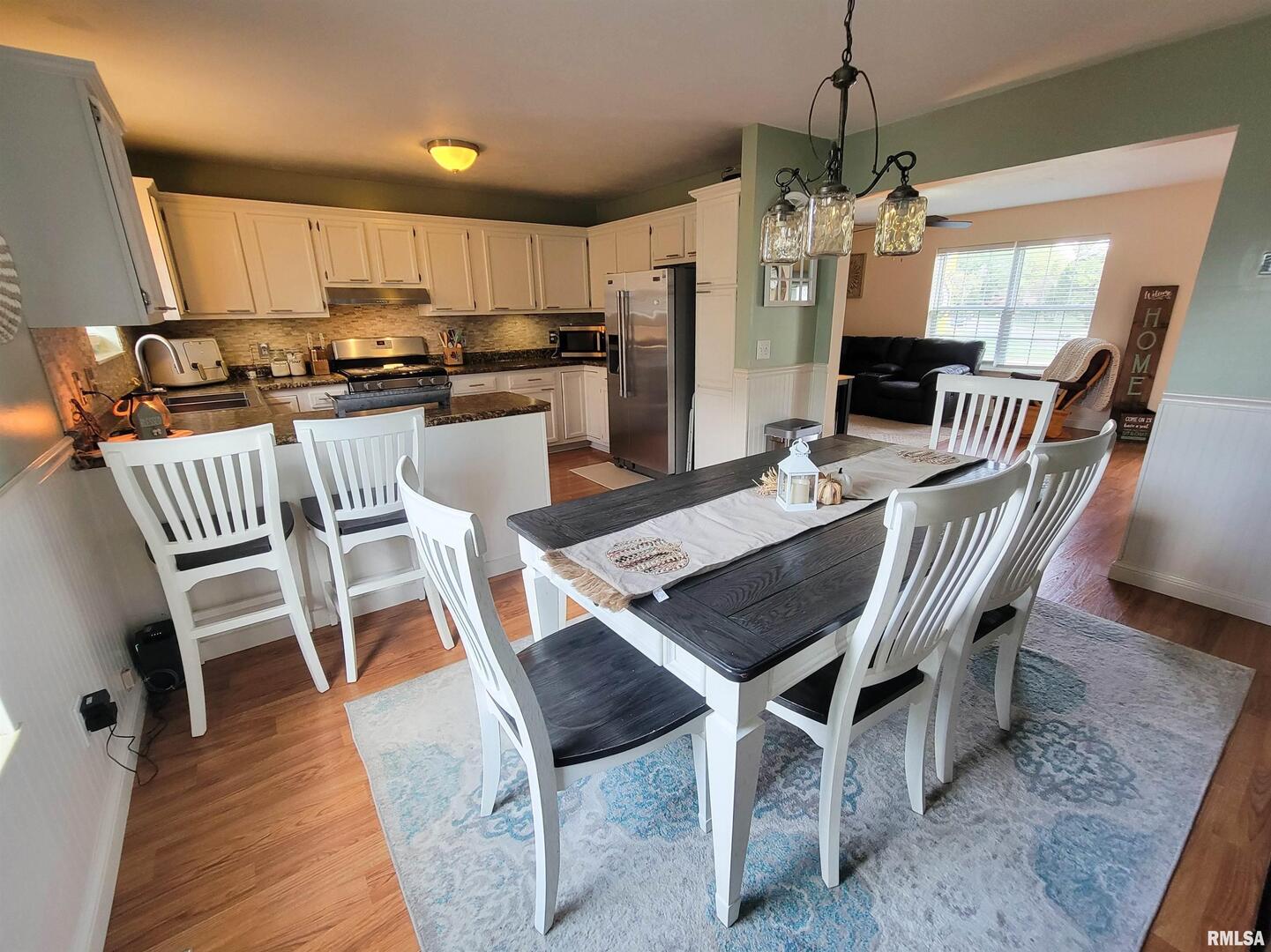 16 Stone Forge Pike Flora, IL 62839 - Photo 24 of 98 a dining room with furniture a chandelier and wooden floor