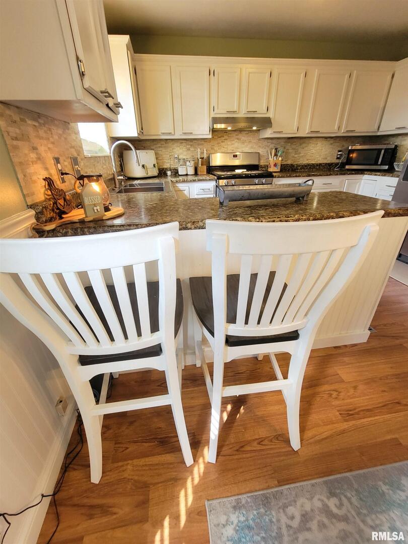 16 Stone Forge Pike Flora, IL 62839 - Photo 26 of 98 a kitchen with kitchen island granite countertop wooden cabinets and white appliances