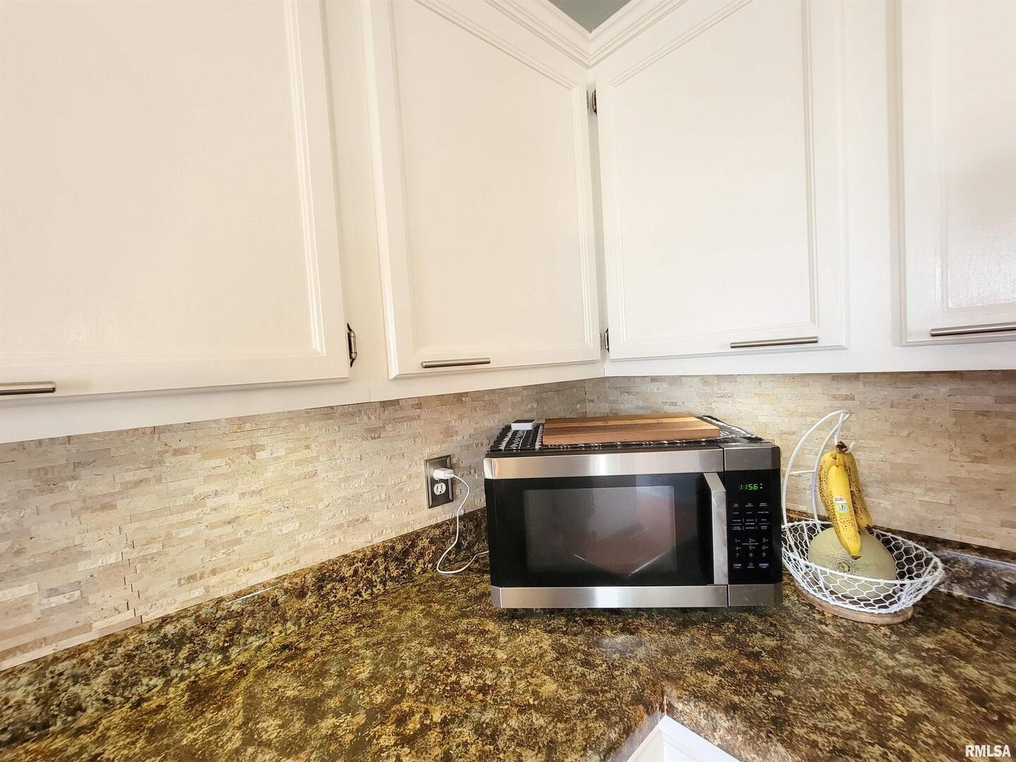 16 Stone Forge Pike Flora, IL 62839 - Photo 28 of 98 a kitchen with granite countertop a stove and a white cabinets