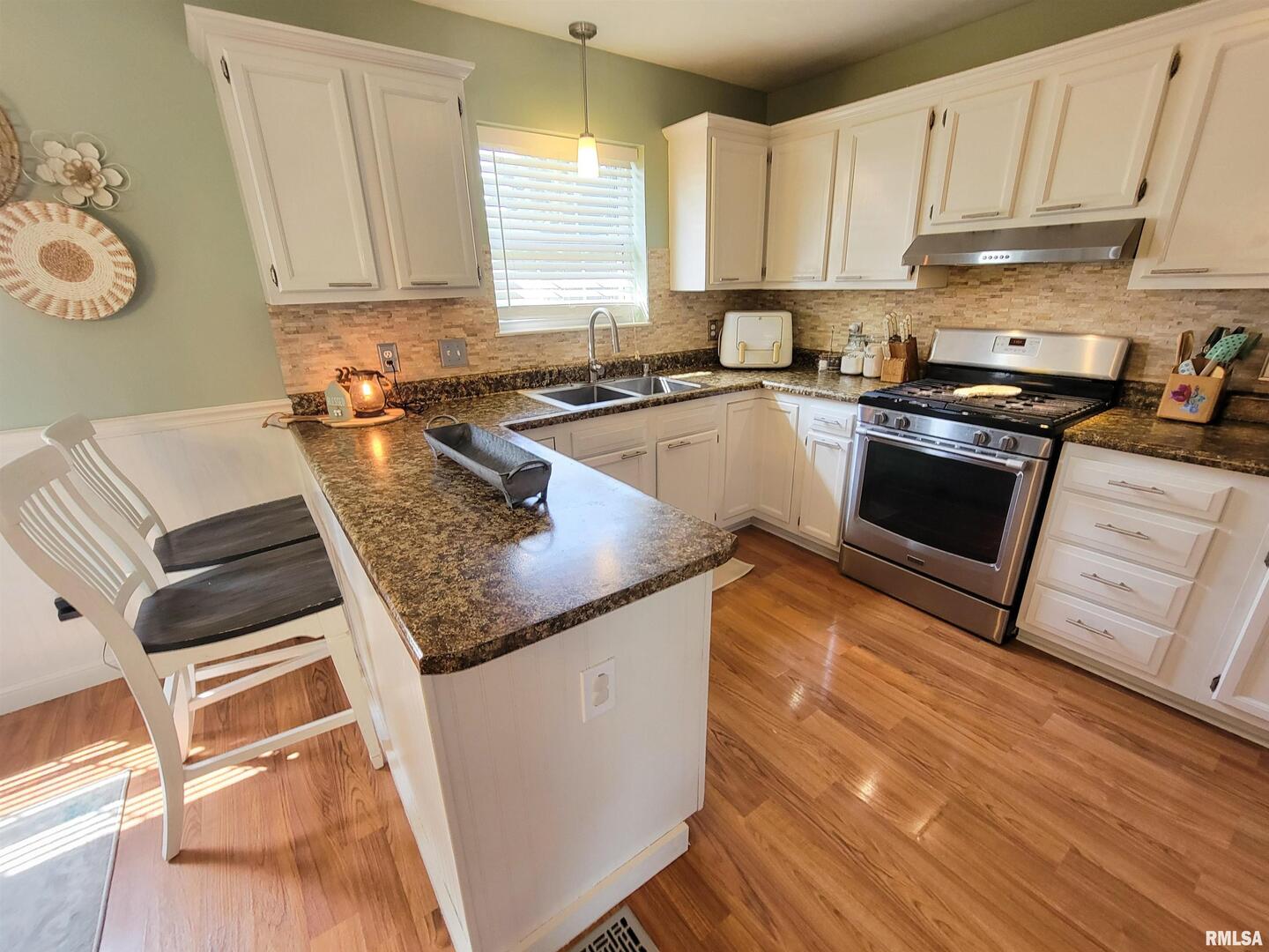16 Stone Forge Pike Flora, IL 62839 - Photo 37 of 98 a kitchen with stainless steel appliances granite countertop a stove a sink and a microwave