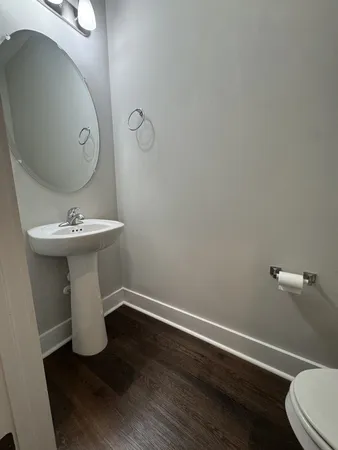 a bathroom with a sink toilet and mirror