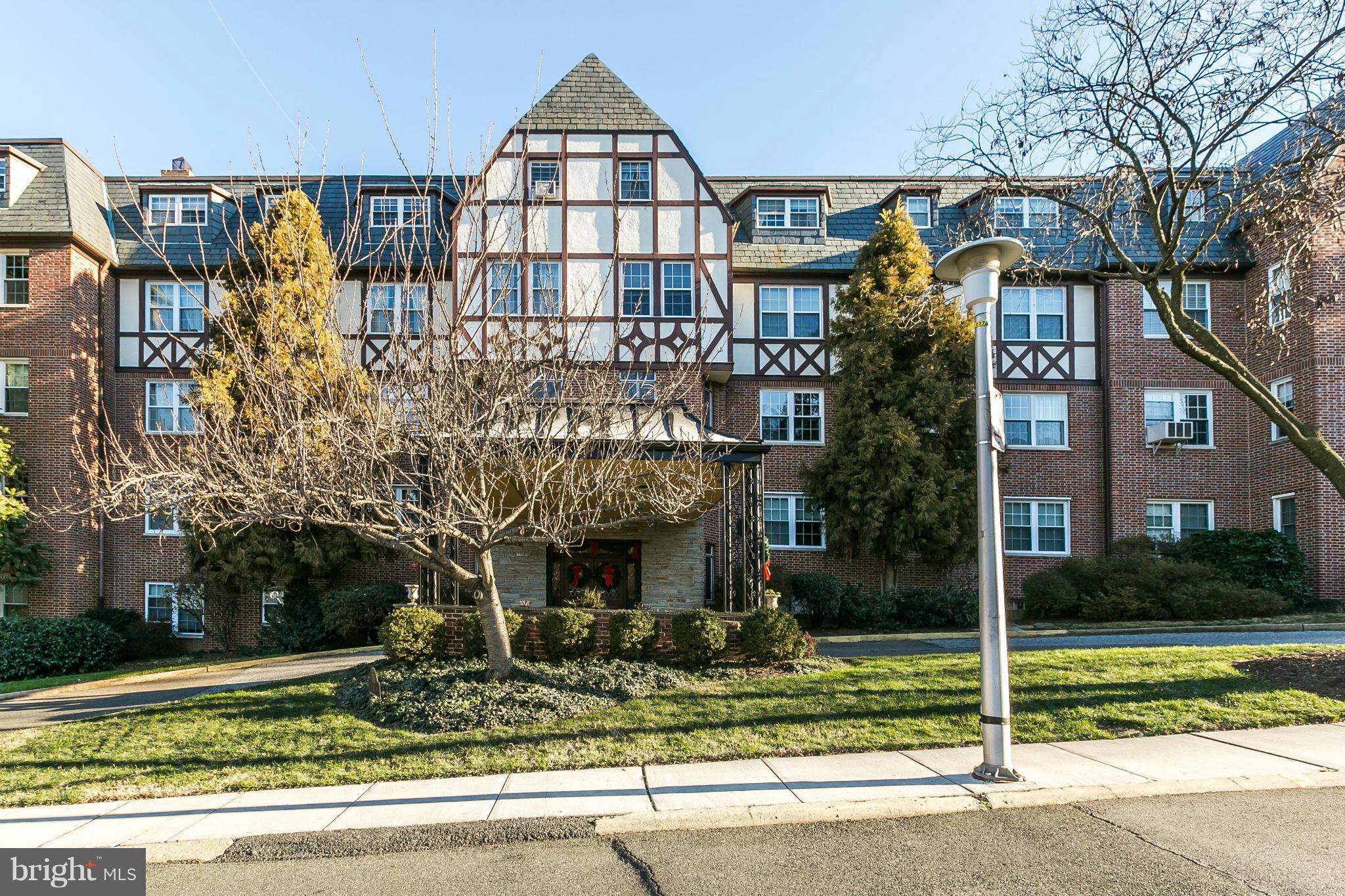 310 Ridgemede Road, Unit 107 Baltimore, MD 21210 - Photo 2 of 28 a front view of a house with garden