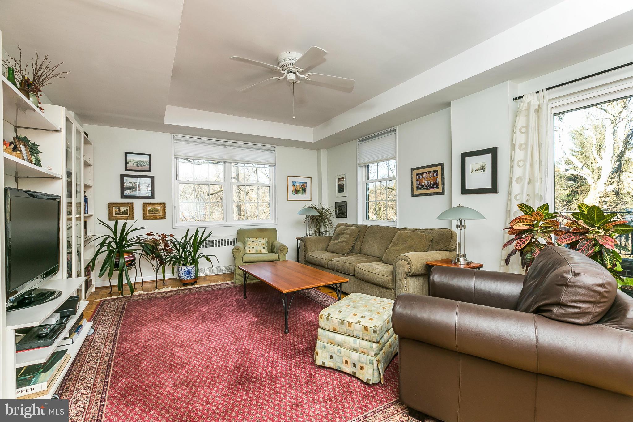 310 Ridgemede Road, Unit 107 Baltimore, MD 21210 - Photo 19 of 28 a living room with furniture and a flat screen tv