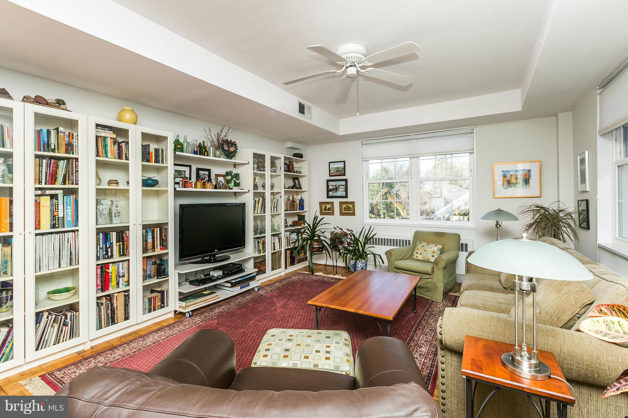 310 Ridgemede Road, Unit 107 Baltimore, MD 21210 - Photo 20 of 28 a living room with furniture workspace and a flat screen tv