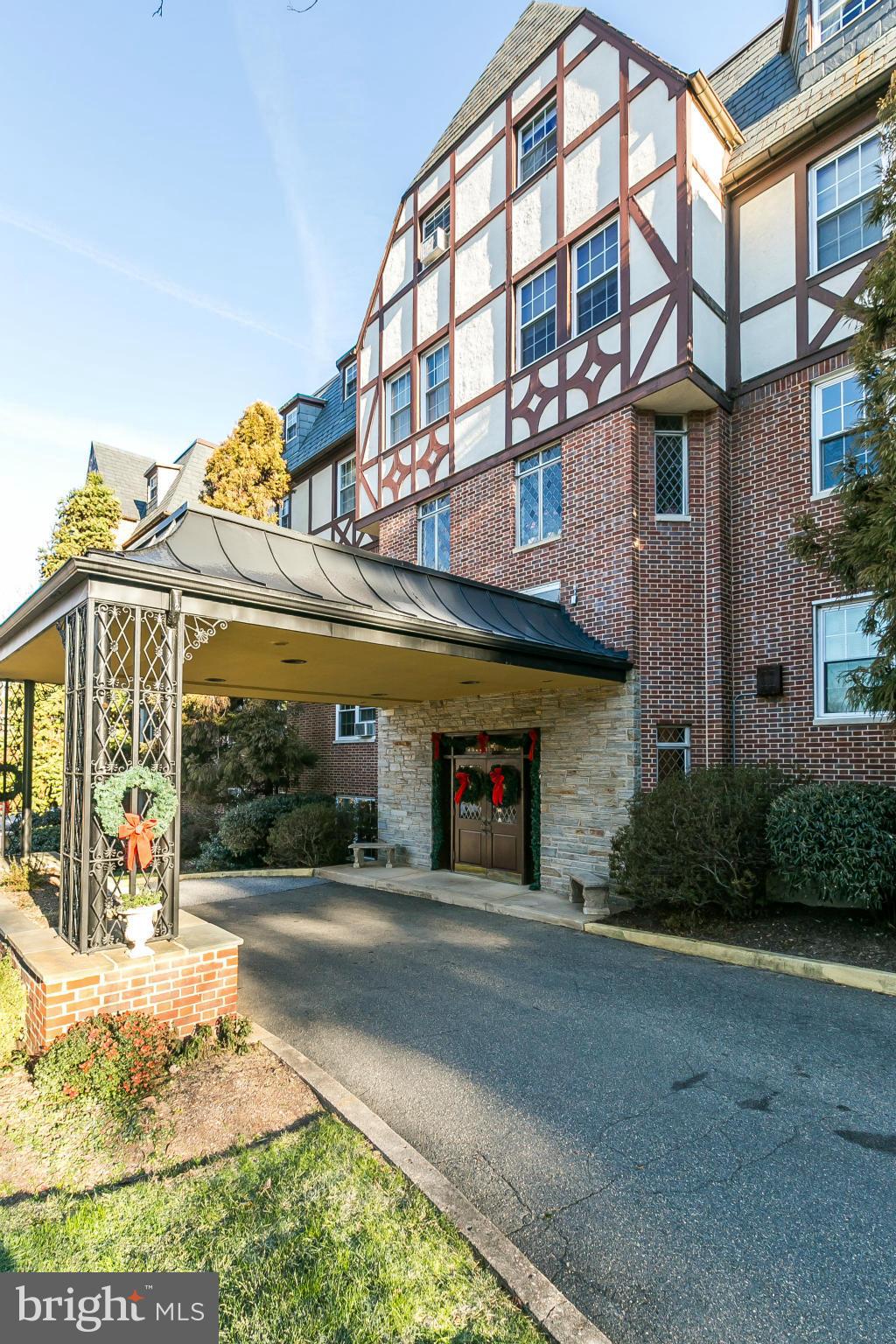 310 Ridgemede Road, Unit 107 Baltimore, MD 21210 - Photo 3 of 28 a front view of a building and a yard
