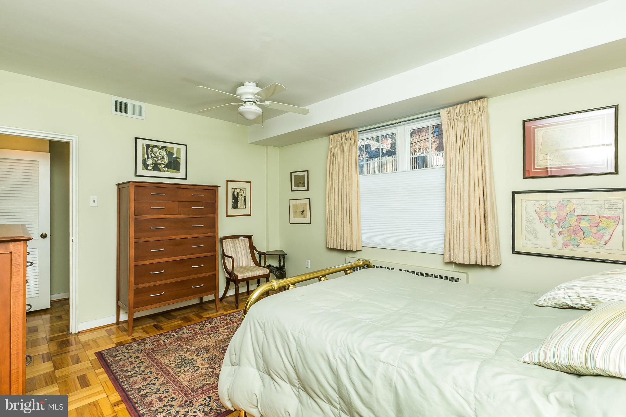310 Ridgemede Road, Unit 107 Baltimore, MD 21210 - Photo 24 of 28 a bed room with a bed and dresser