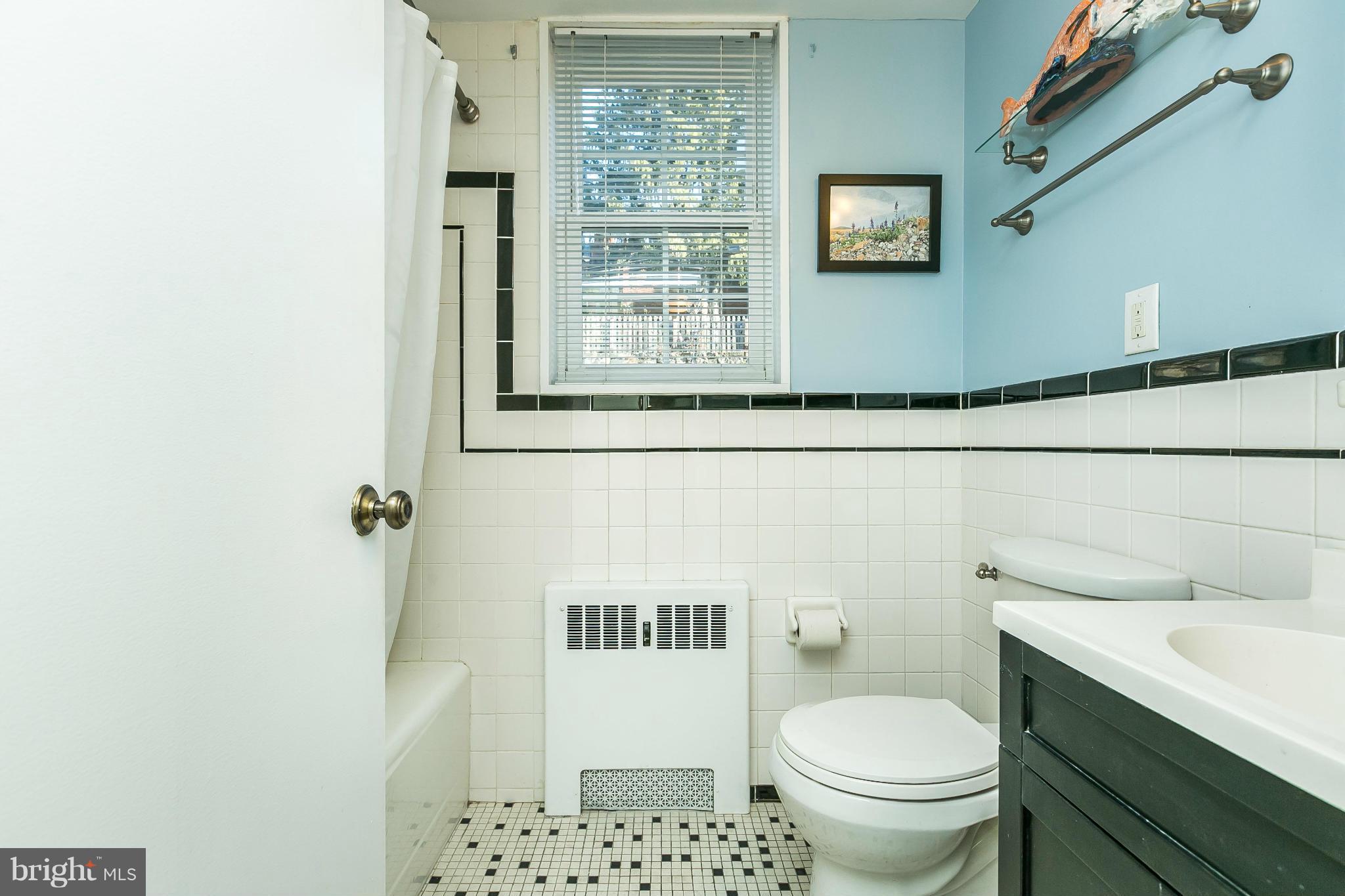 310 Ridgemede Road, Unit 107 Baltimore, MD 21210 - Photo 25 of 28 a bathroom with a toilet a sink and a window