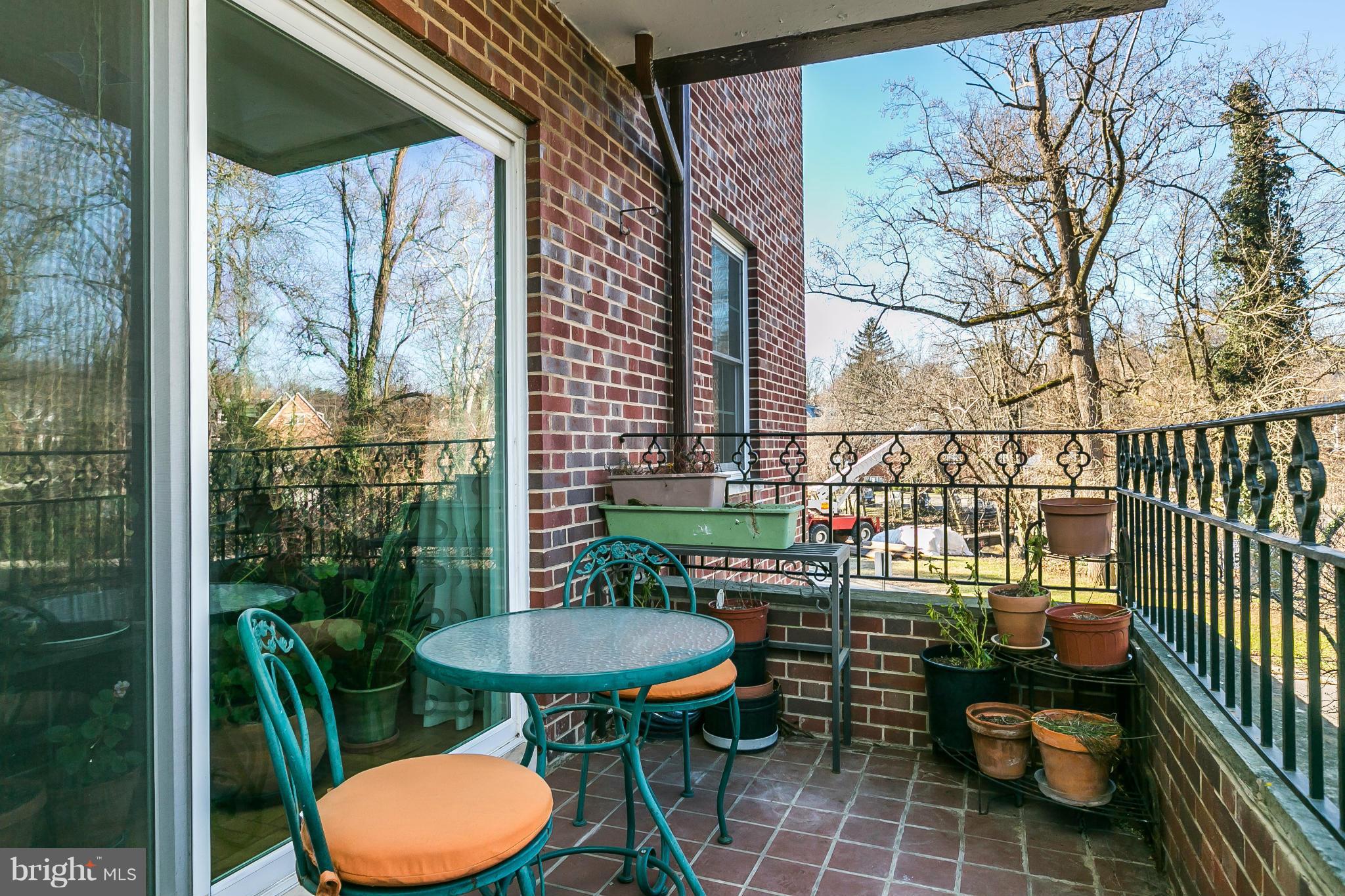 310 Ridgemede Road, Unit 107 Baltimore, MD 21210 - Photo 28 of 28 a view of a balcony with chairs and a potted plant