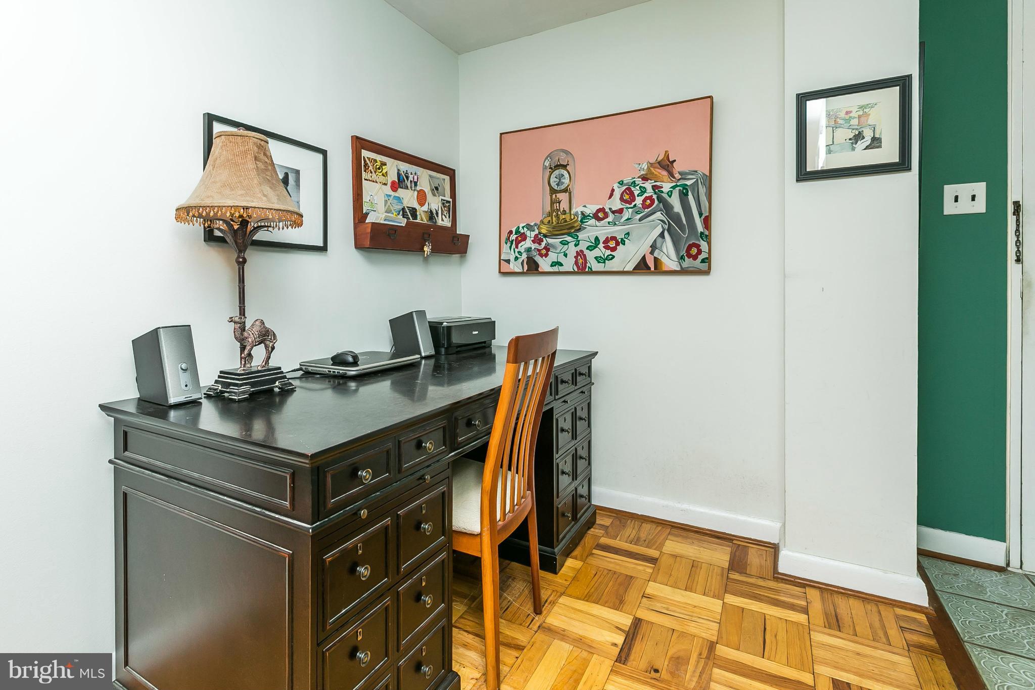 310 Ridgemede Road, Unit 107 Baltimore, MD 21210 - Photo 6 of 28 a view of a workspace with furniture and paintings on the wall