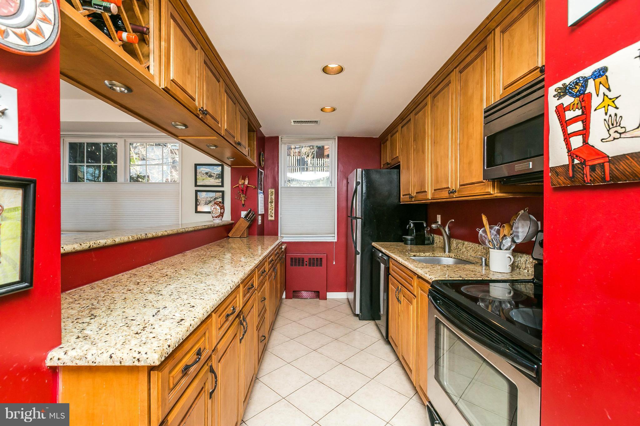 310 Ridgemede Road, Unit 107 Baltimore, MD 21210 - Photo 8 of 28 a kitchen with stainless steel appliances granite countertop a stove and cabinets