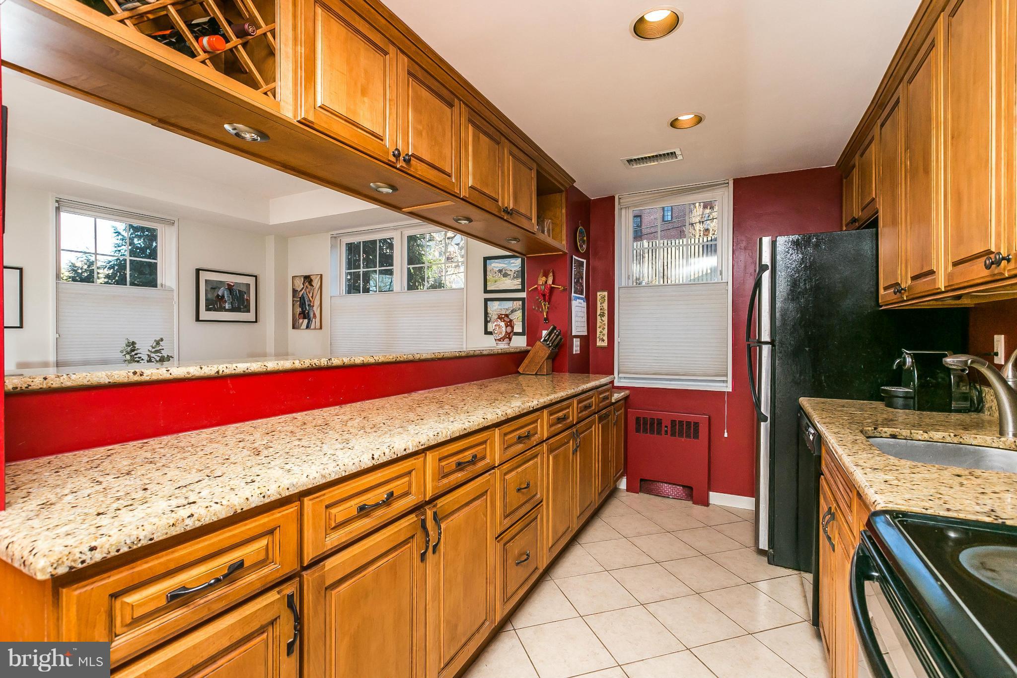 310 Ridgemede Road, Unit 107 Baltimore, MD 21210 - Photo 10 of 28 a kitchen with stainless steel appliances granite countertop a stove a sink and a refrigerator