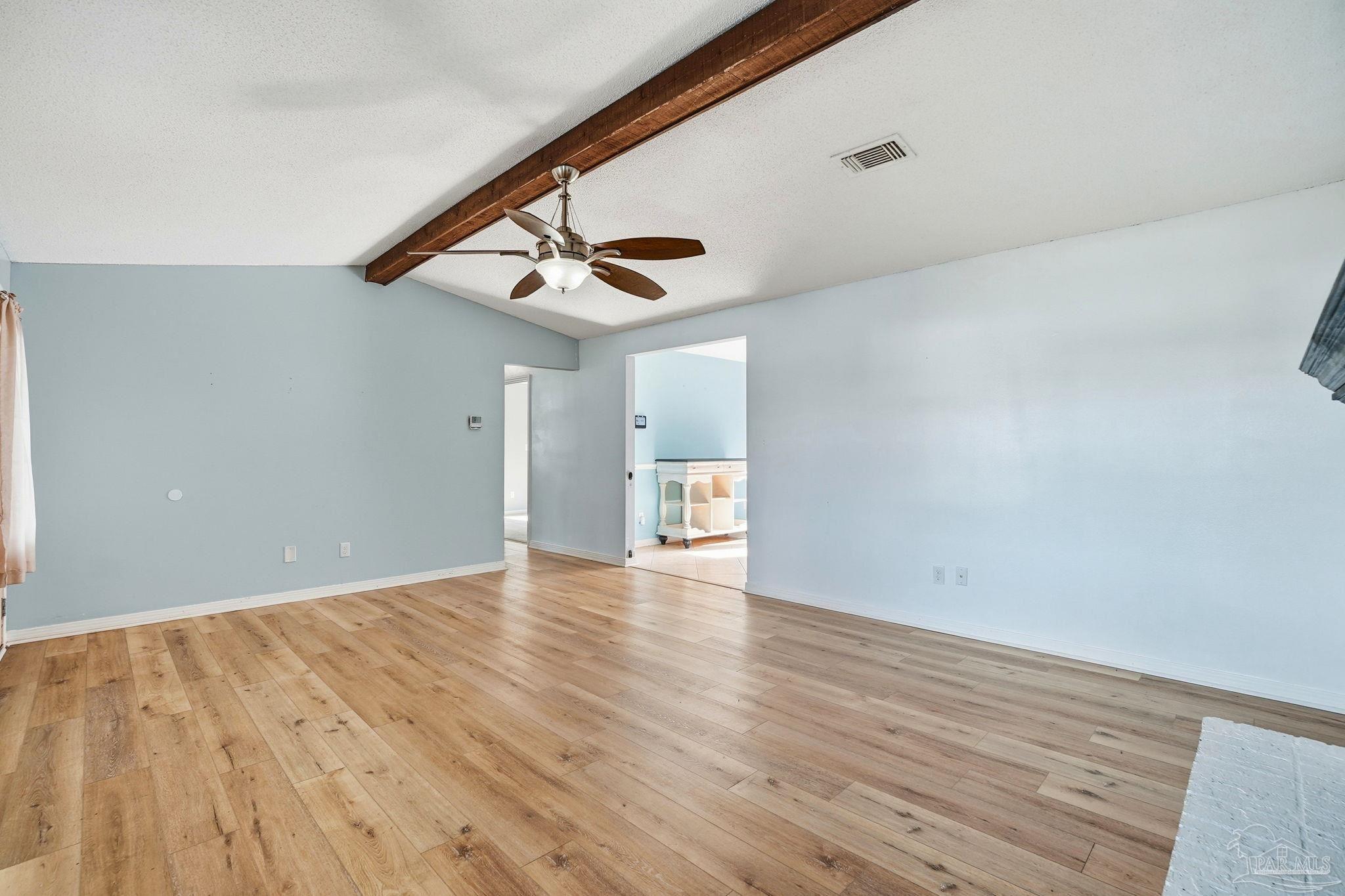 4605 Heatherwood Way Pace, FL 32571 - Photo 29 of 37 a view of an empty room with wooden floor and a ceiling fan
