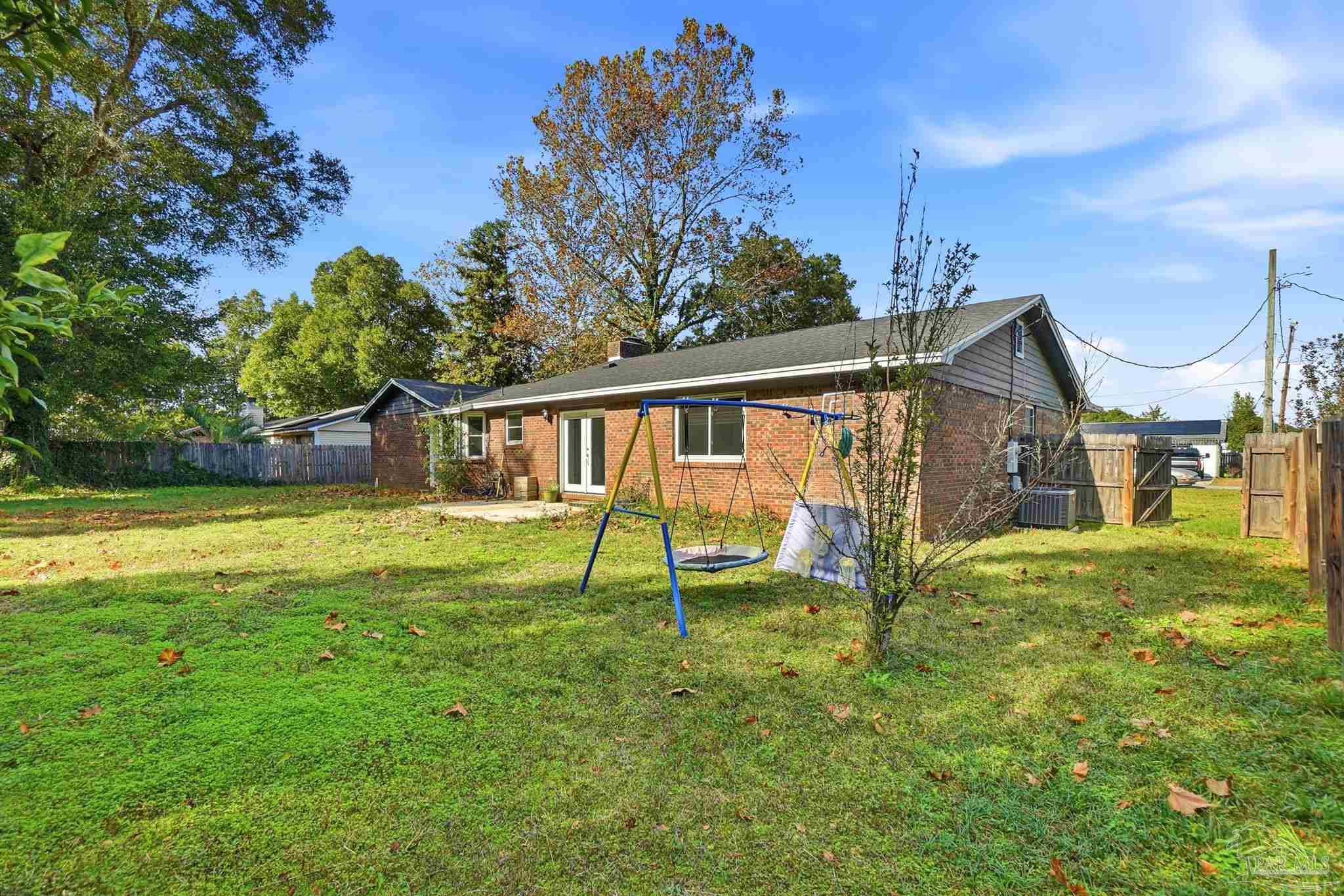 4605 Heatherwood Way Pace, FL 32571 - Photo 3 of 37 a view of a house with a yard