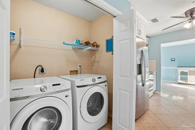a view of a storage & utility room with dryer and washer