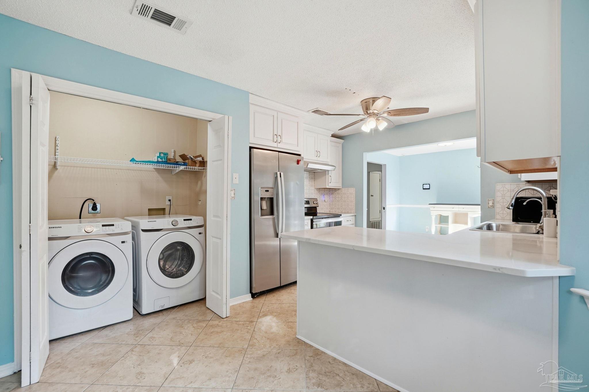 4605 Heatherwood Way Pace, FL 32571 - Photo 8 of 37 a view of a kitchen with refrigerator and cabinets