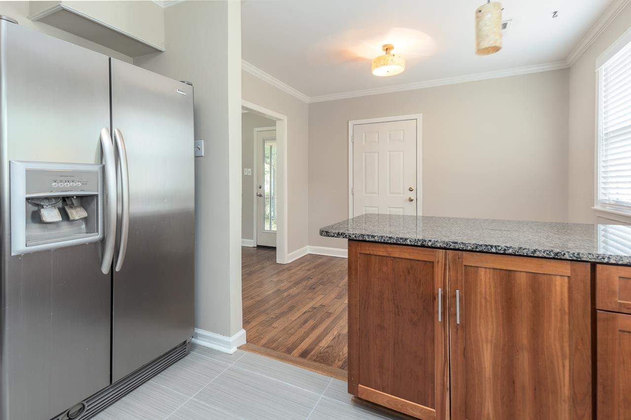 4951 Sequoia Road Memphis, TN 38117 - Photo 10 of 21 a view of a refrigerator in kitchen and wooden floor