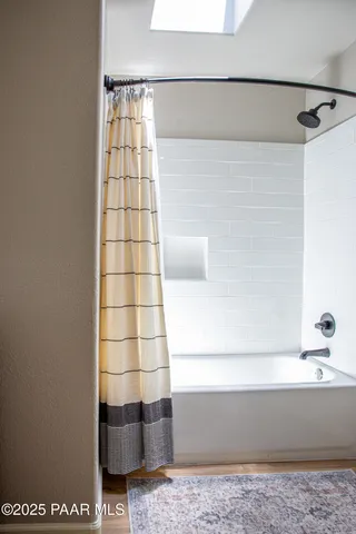 a bathroom with a bathtub and a shower