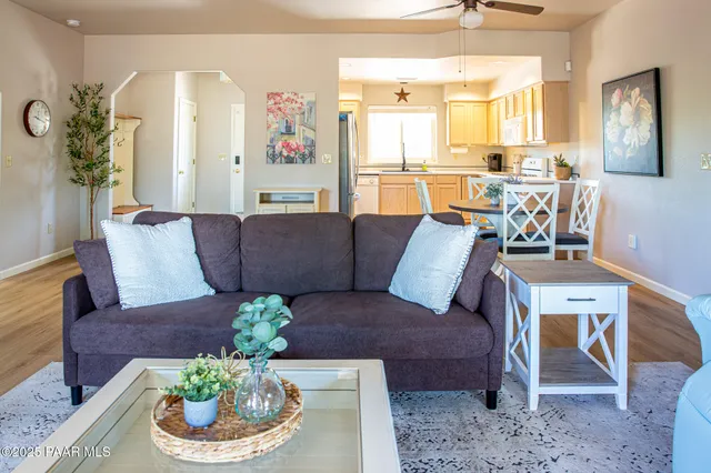 a living room with furniture and a dining room