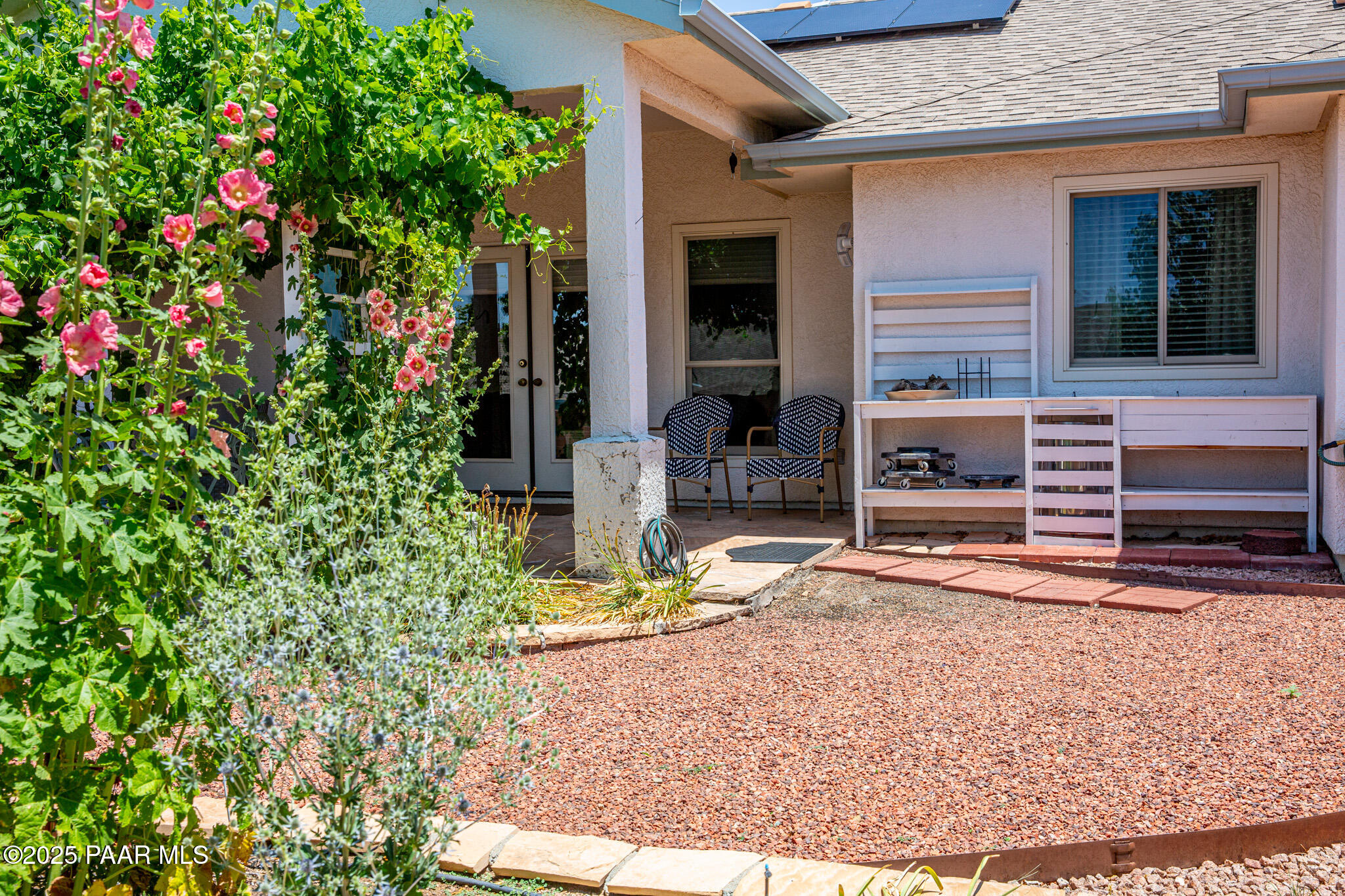 7075 Horizon Way Prescott Valley, AZ 86315 - Photo 37 of 44 a view of yellow house with potted plants in front of door