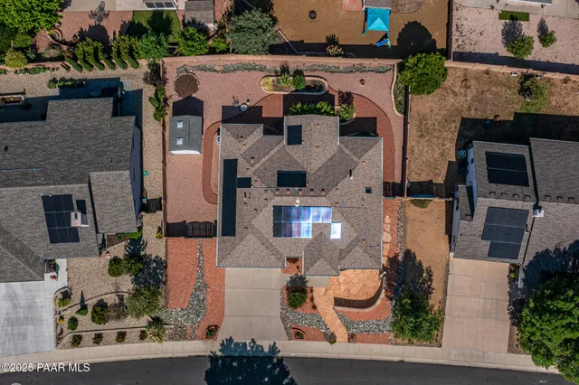 an aerial view of a house with a yard