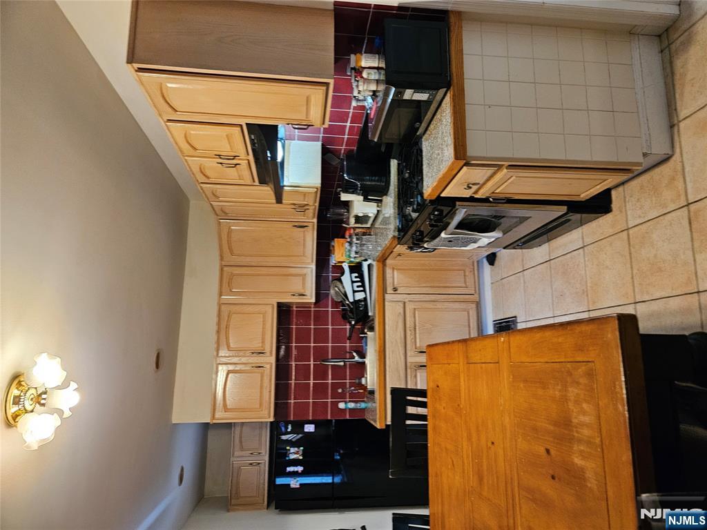 575 High Mountain Road, Unit 3 North Haledon, NJ 07508 - Photo 5 of 10 a kitchen with stainless steel appliances granite countertop a stove a sink and a refrigerator