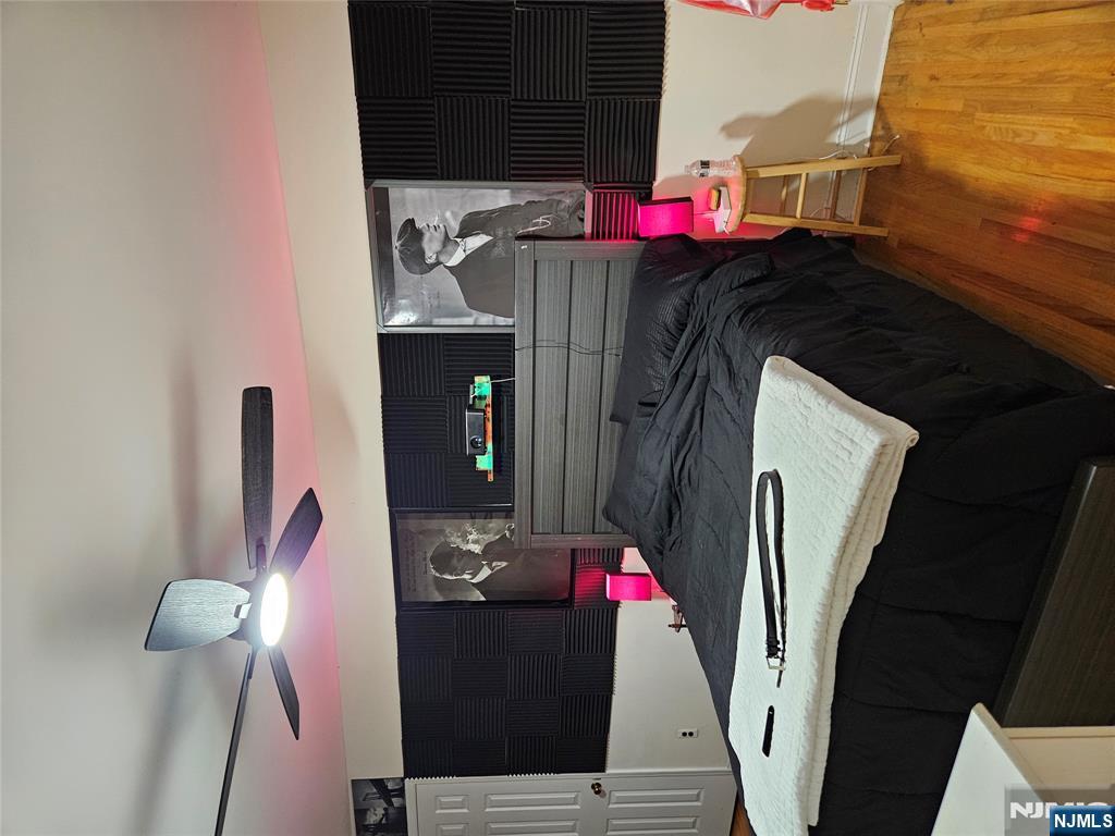 575 High Mountain Road, Unit 3 North Haledon, NJ 07508 - Photo 7 of 10 a bedroom with a bed and a flat screen tv