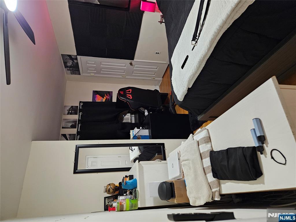 575 High Mountain Road, Unit 3 North Haledon, NJ 07508 - Photo 8 of 10 a bedroom with a bed and a flat screen tv