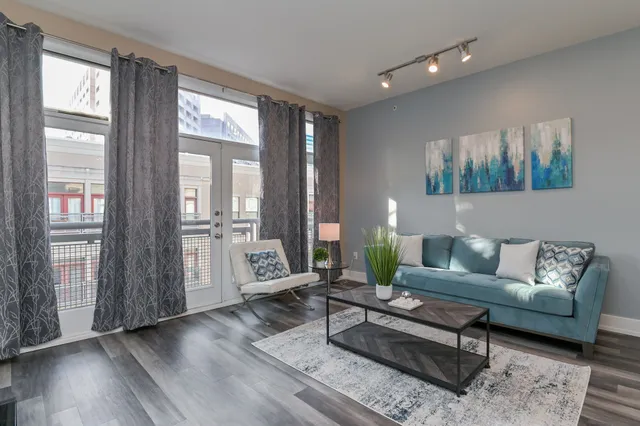a living room with furniture and wooden floor