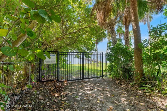 an aerial view of a house with a yard and lake view