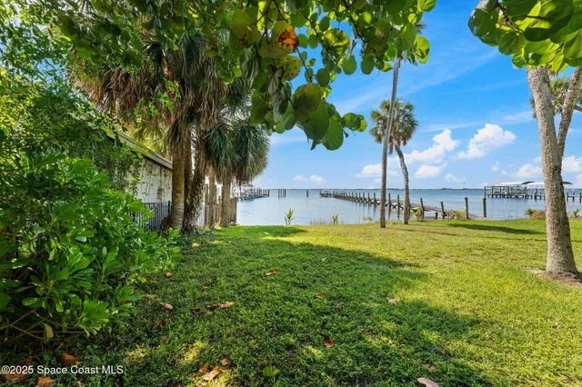 an aerial view of a houses with a lake view