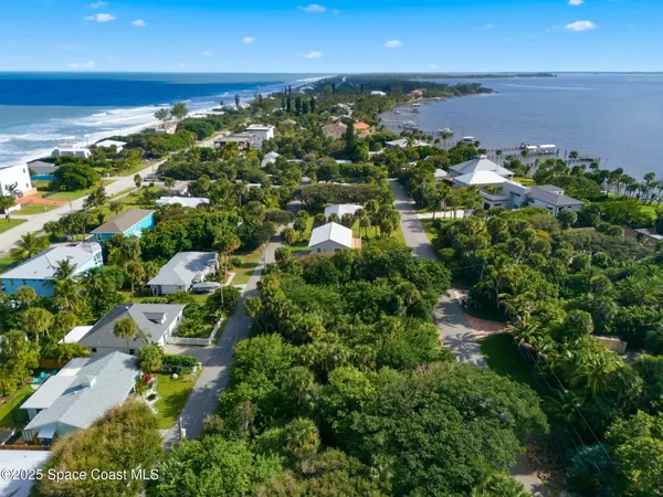 an aerial view of a houses with a yard