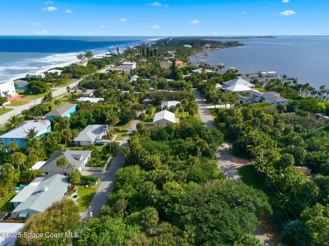 an aerial view of a houses with a yard