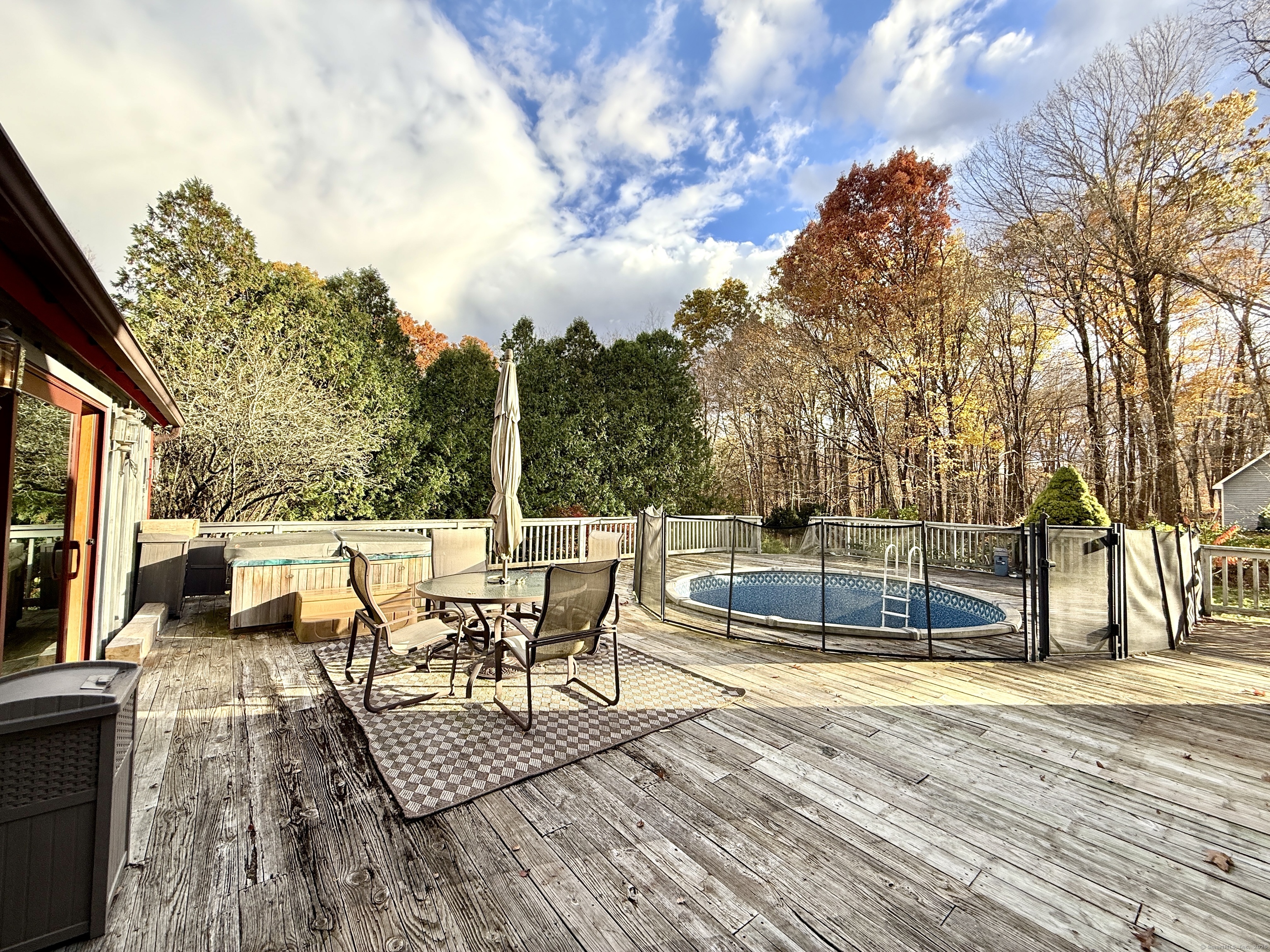 102 Krapf Road Ashford, CT 06278 - Photo 36 of 39 a view of a patio with dining table and chairs with wooden floor and fence