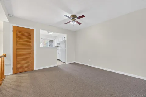 an empty room with closet and windows