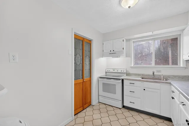 a kitchen with a sink cabinets and window