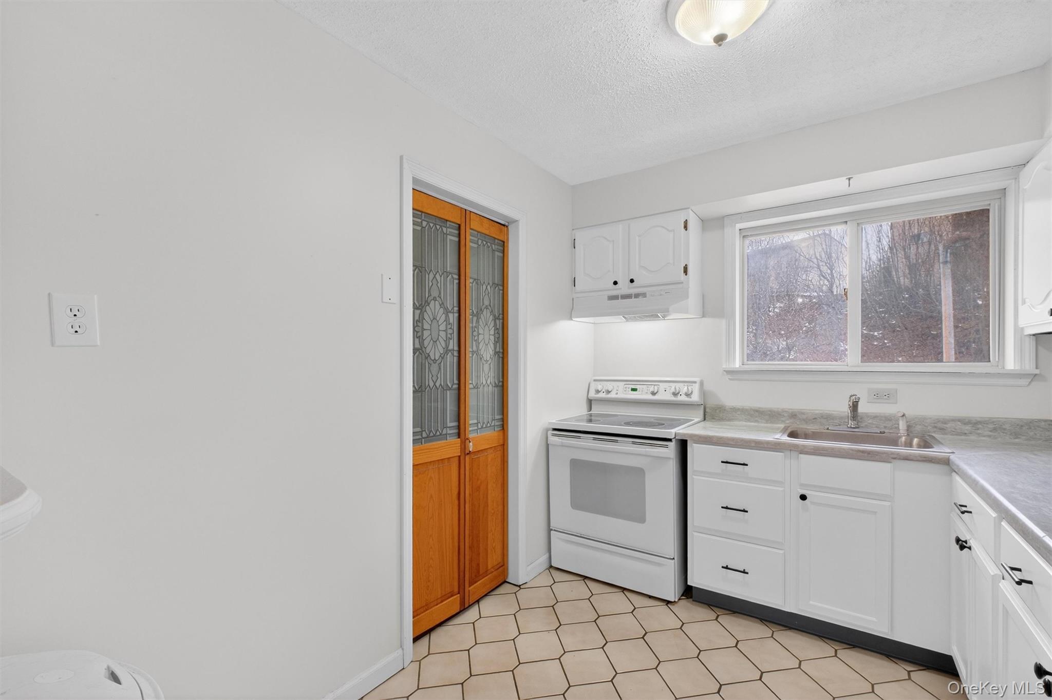 26 Cooper Road, Unit 715 Poughkeepsie, NY 12603 - Photo 14 of 30 a kitchen with a sink cabinets and window