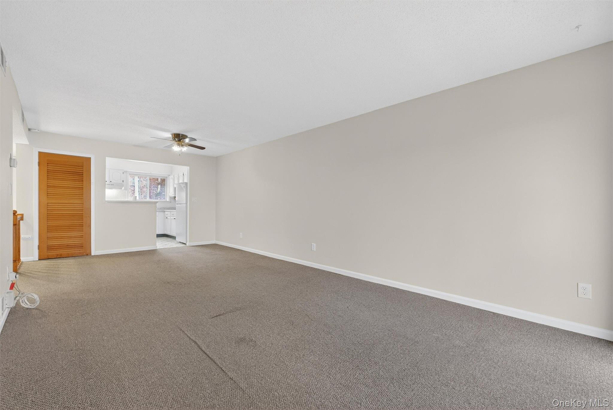 26 Cooper Road, Unit 715 Poughkeepsie, NY 12603 - Photo 14 of 30 Empty room with carpet and ceiling fan