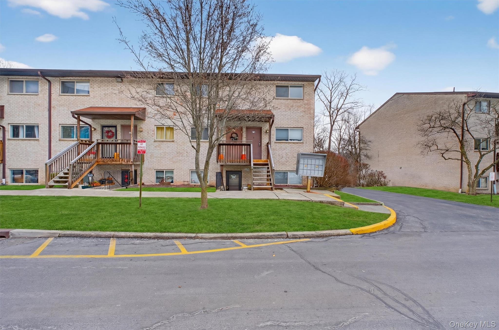 26 Cooper Road, Unit 715 Poughkeepsie, NY 12603 - Photo 2 of 30 a front view of a house with a yard and a garage